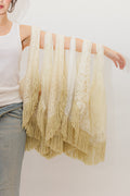 Person holding multiple cream lace totes on arm against a white background